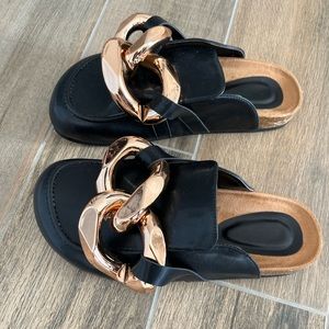 Black leather mules with large buckle